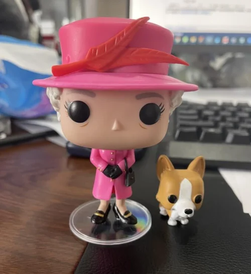 Queen of England character and corgi scale model